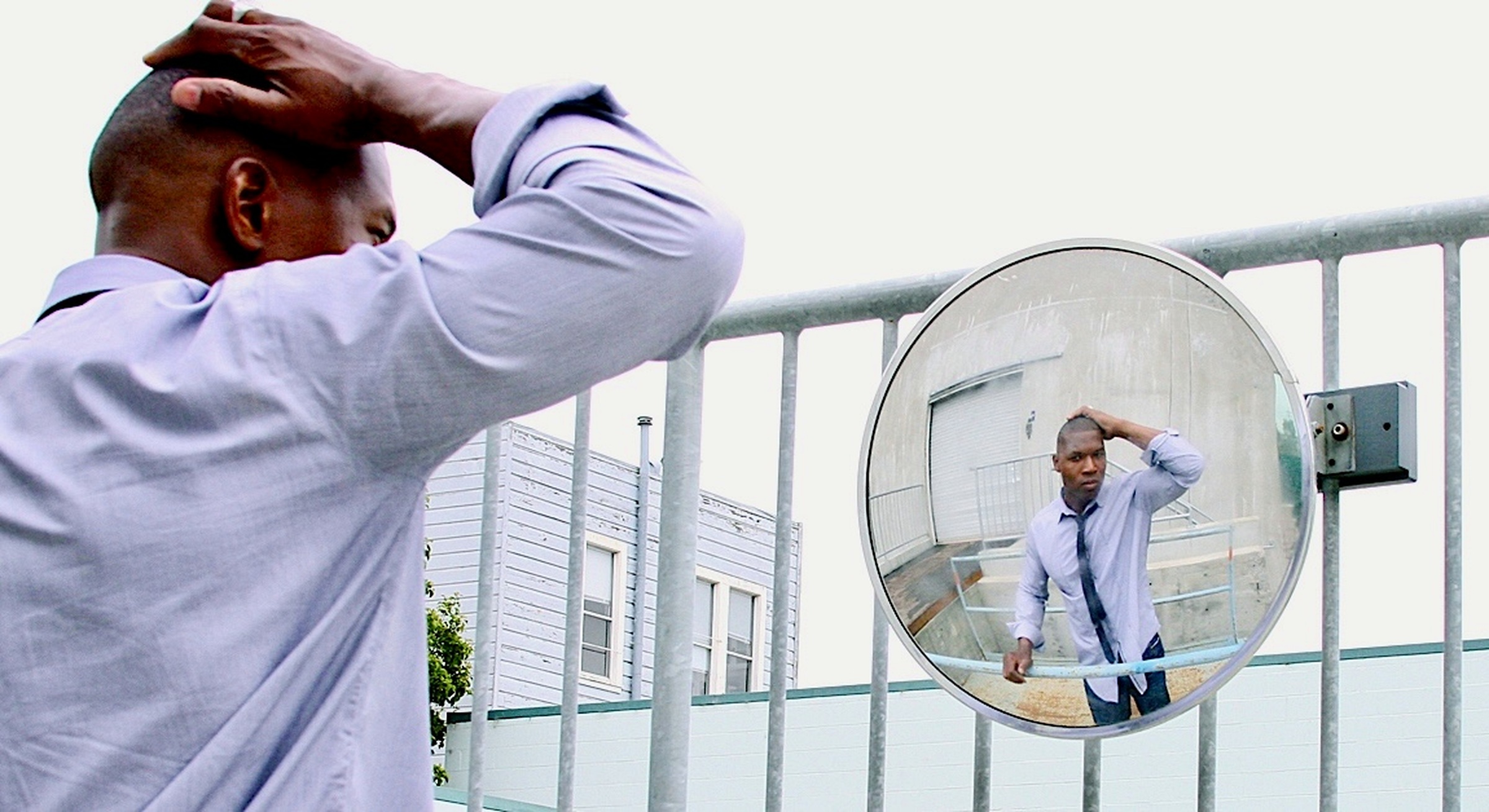 Lawrence Beamen reflected in a convex street mirror after a long day