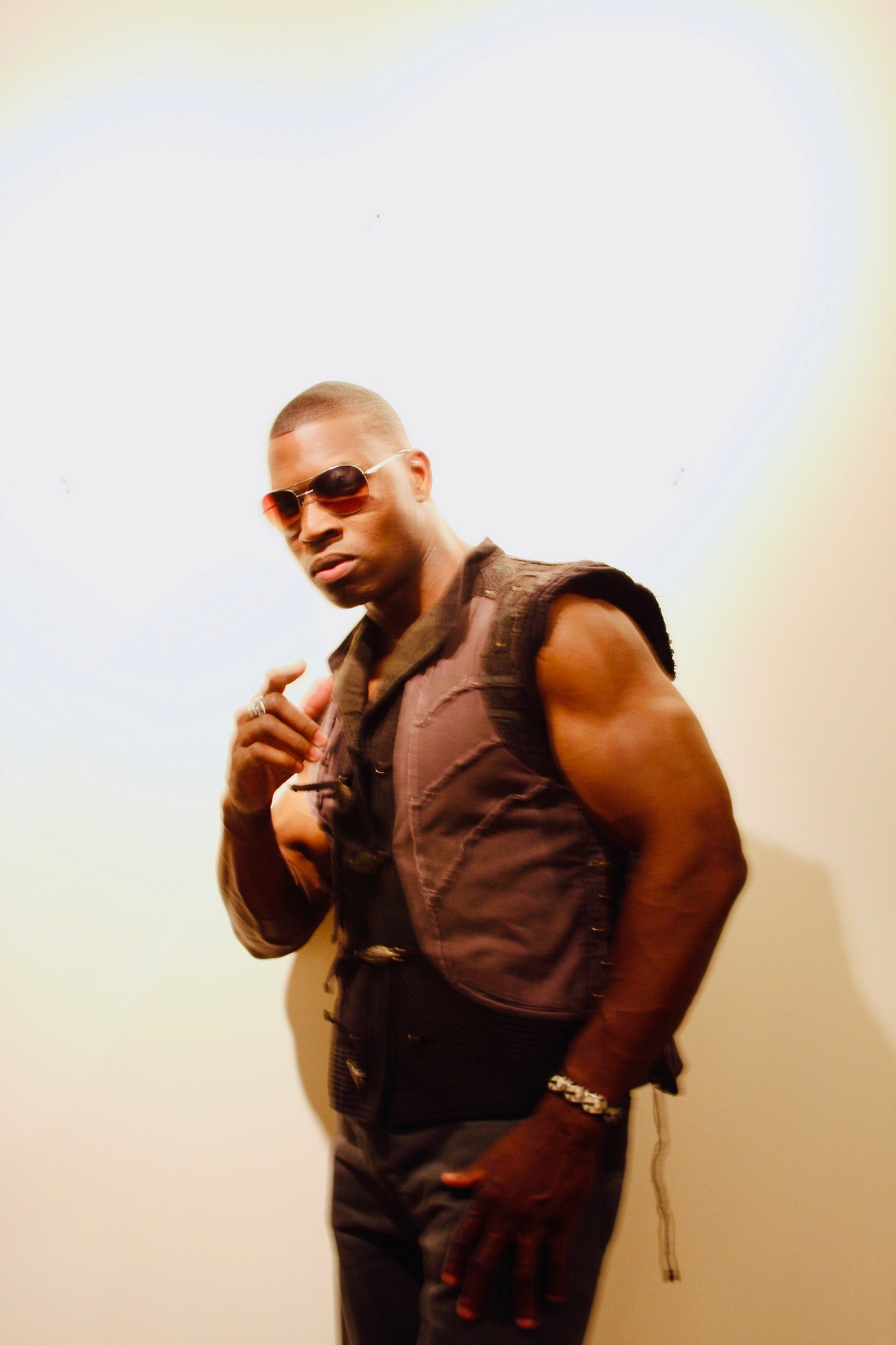 Lawrence Beamen posing in aviators and a sleeveless vest
